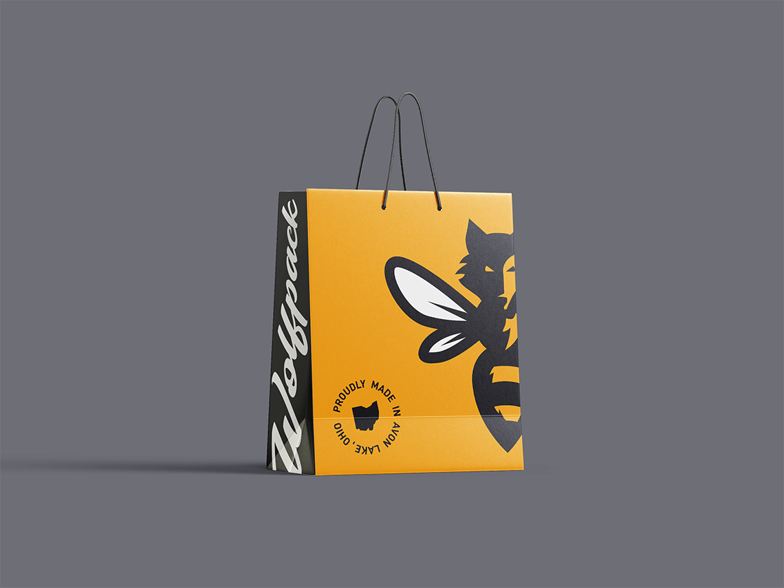 Merch retail shopping gift bag design for dynamic bold modern local Ohio honey company Wolfpack Honey by freelance graphic designer and illustrator Rick Martin